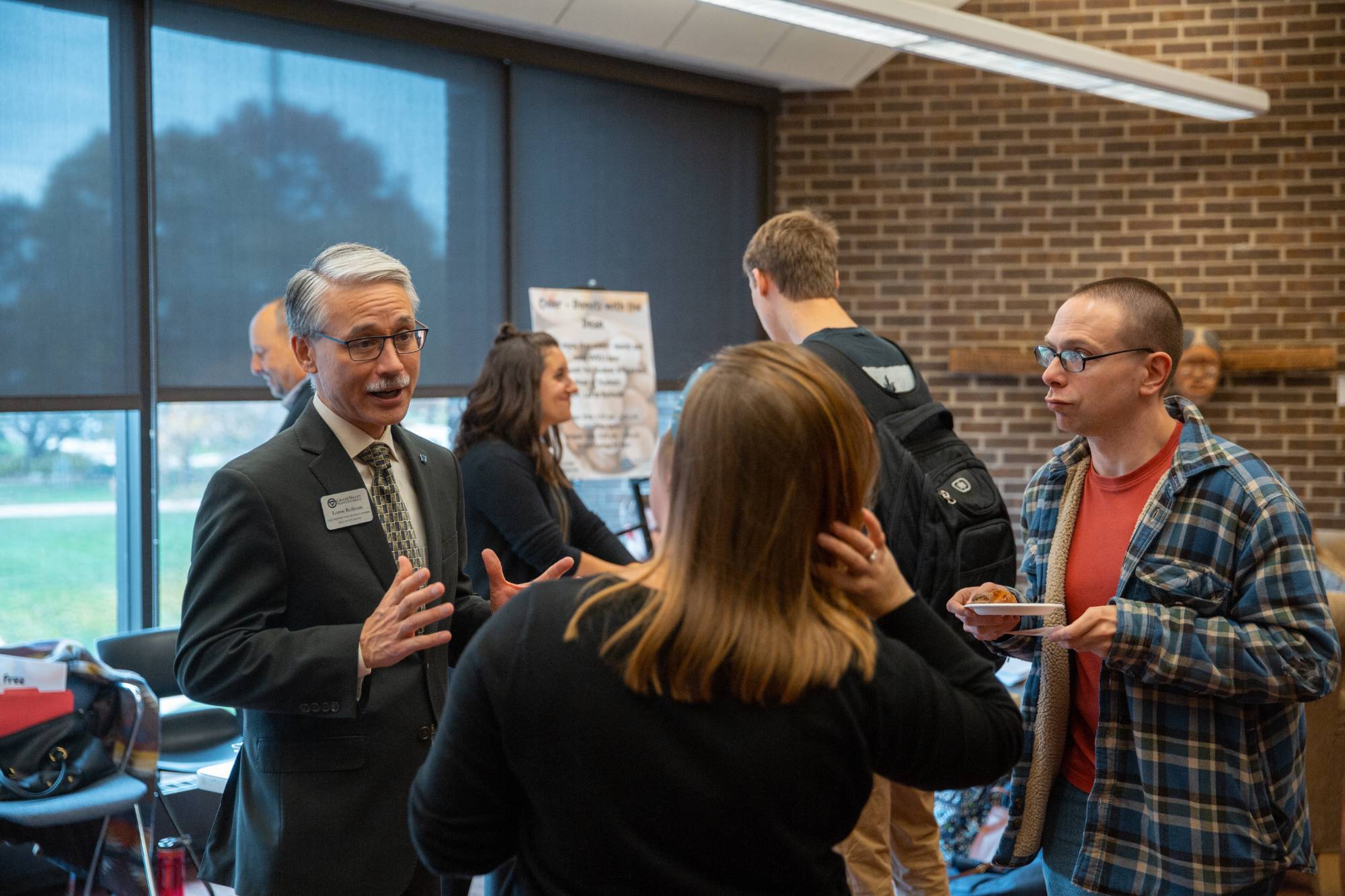 GVSU students speaking with a presenter
